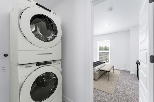841 States Ave, Bentonville, AR 72713 - laundry area featuring stacked washing machine and dryer, carpet flooring, and baseboards