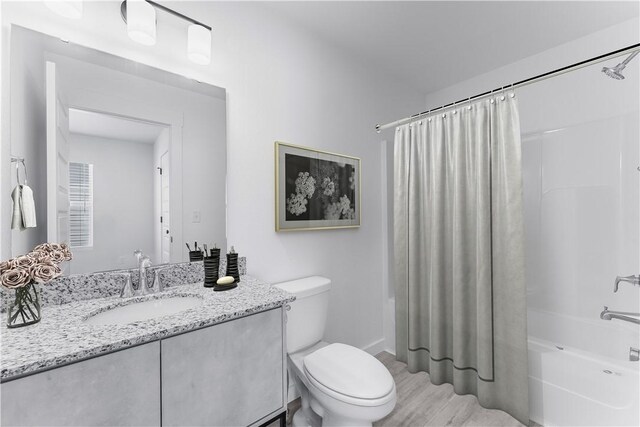 841 States Ave, Bentonville, AR 72713 - full bath with vanity, toilet, shower / bath combination with curtain, and wood finished floors