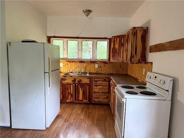 120 Walnut Rdg, Berryville, AR 72616 - kitchen featuring white appliances, light wood-type flooring, brown cabinets, and dark countertops
