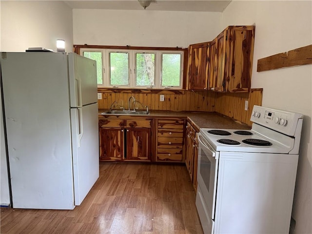 120 Walnut Rdg, Berryville, AR 72616 - kitchen with white appliances, light wood-style flooring, dark countertops, and brown cabinetry