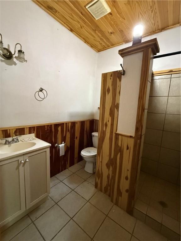 120 Walnut Rdg, Berryville, AR 72616 - full bathroom with a wainscoted wall, wooden ceiling, tile patterned flooring, vanity, and wooden walls