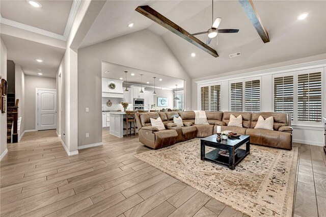 1300 Eureka Rd, Centerton, AR 72719 - living room featuring a ceiling fan, high vaulted ceiling, light wood-style floors, beam ceiling, and baseboards