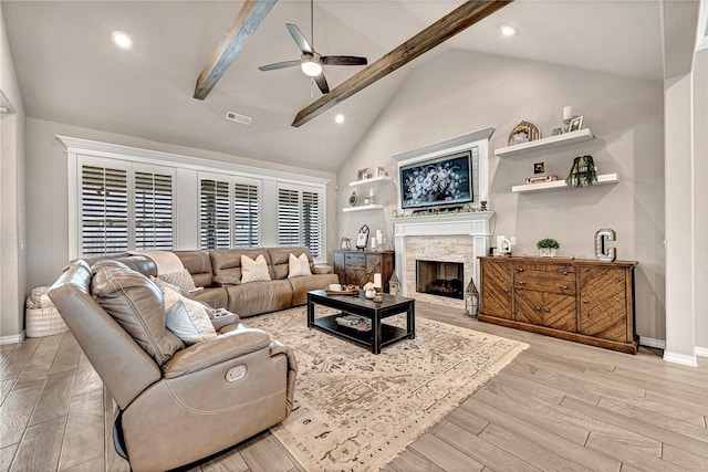 1300 Eureka Rd, Centerton, AR 72719 - living room featuring a ceiling fan, beamed ceiling, baseboards, light wood finished floors, and a fireplace