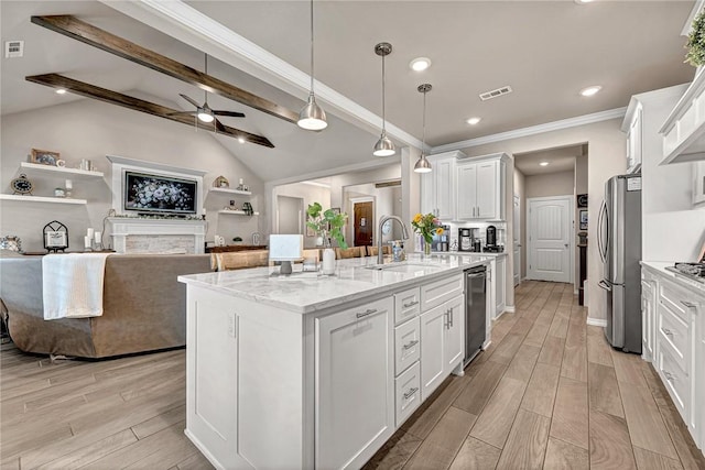 1300 Eureka Rd, Centerton, AR 72719 - kitchen with a sink, freestanding refrigerator, white cabinetry, ceiling fan, and ornamental molding
