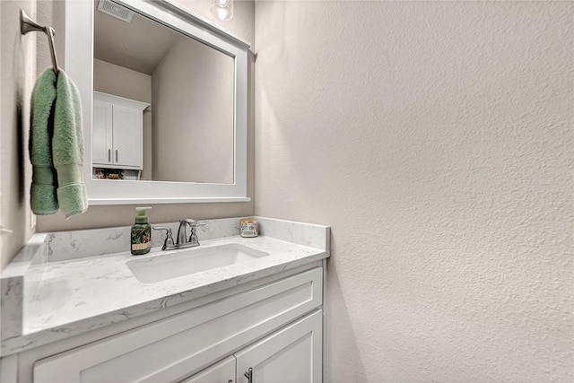 1300 Eureka Rd, Centerton, AR 72719 - bathroom with a textured wall and vanity