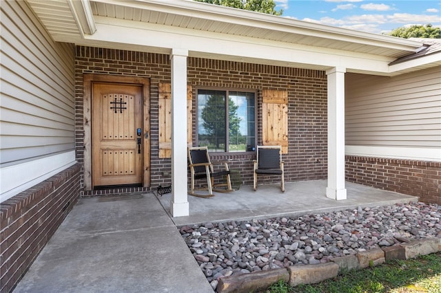 6108 SW Lee Ln, Bentonville, AR 72713 - view of exterior entry with brick siding and covered porch