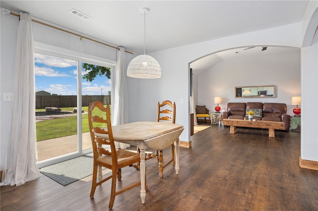 6108 SW Lee Ln, Bentonville, AR 72713 - dining space with arched walkways, dark wood-style floors, and baseboards