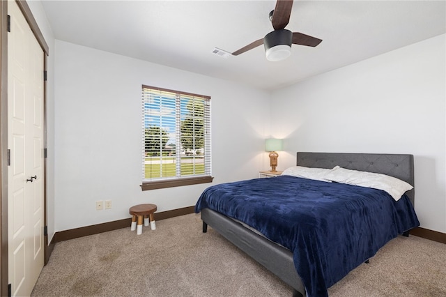 6108 SW Lee Ln, Bentonville, AR 72713 - carpeted bedroom with baseboards and a ceiling fan