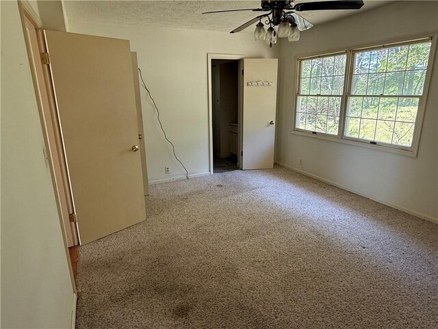 7 Bobwhite Ln, Holiday Island, AR 72631 - unfurnished bedroom featuring carpet, baseboards, a textured ceiling, and ceiling fan