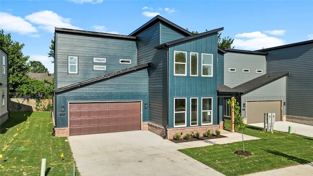 1209 SW Journey Ln, Bentonville, AR 72713 - contemporary home featuring board and batten siding, concrete driveway, and a front lawn