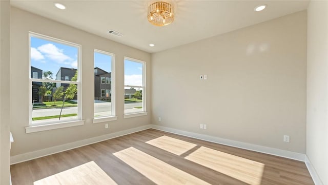 1209 SW Journey Ln, Bentonville, AR 72713 - unfurnished room with wood finished floors, recessed lighting, and a chandelier
