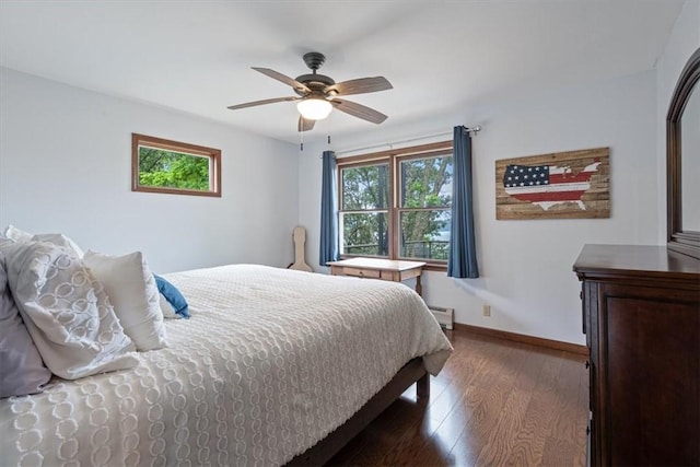 326 Hillcrest Rd, Eureka Springs, AR 72631 - bedroom with wood finished floors, baseboards, a baseboard heating unit, and a ceiling fan