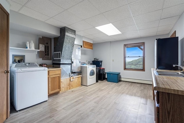 326 Hillcrest Rd, Eureka Springs, AR 72631 - kitchen featuring washer / dryer, a sink, a drop ceiling, a baseboard heating unit, and light wood-style flooring