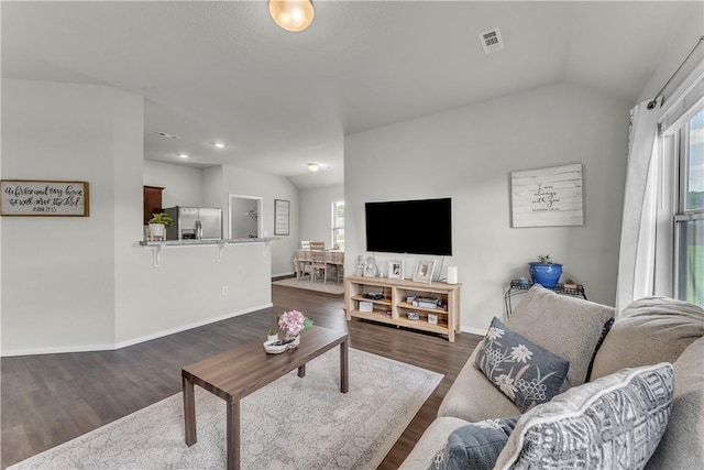 944 Maddy St, Elkins, AR 72727 - living area featuring healthy amount of natural light, vaulted ceiling, and dark wood-type flooring