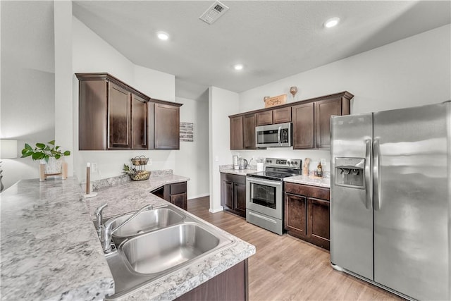944 Maddy St, Elkins, AR 72727 - kitchen with stainless steel appliances, dark brown cabinetry, light wood-style floors, recessed lighting, and a peninsula