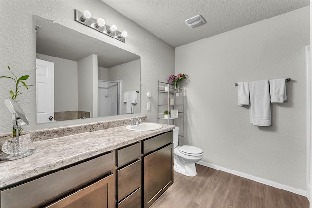 944 Maddy St, Elkins, AR 72727 - full bath featuring wood finished floors, vanity, a textured wall, and a textured ceiling