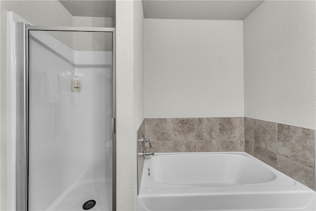 944 Maddy St, Elkins, AR 72727 - bathroom featuring a stall shower, a garden tub, and a textured wall