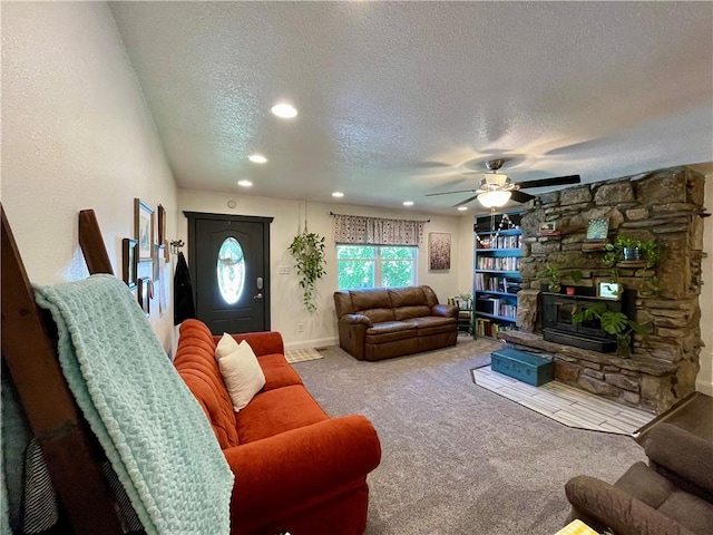 900 Dogwood St, Huntsville, AR 72740 - living area with a textured ceiling, recessed lighting, a ceiling fan, carpet floors, and a stone fireplace