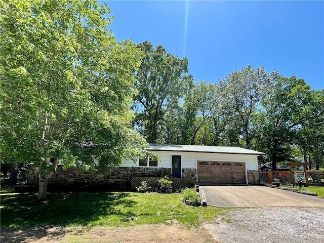 900 Dogwood St, Huntsville, AR 72740 - view of front of property featuring stone siding, driveway, and a garage