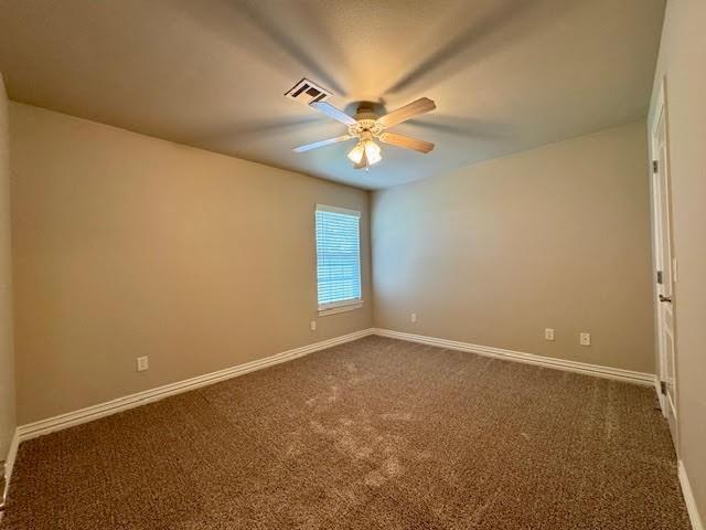 108 Hoss St, Centerton, AR 72719 - unfurnished room featuring a ceiling fan, dark carpet, and baseboards