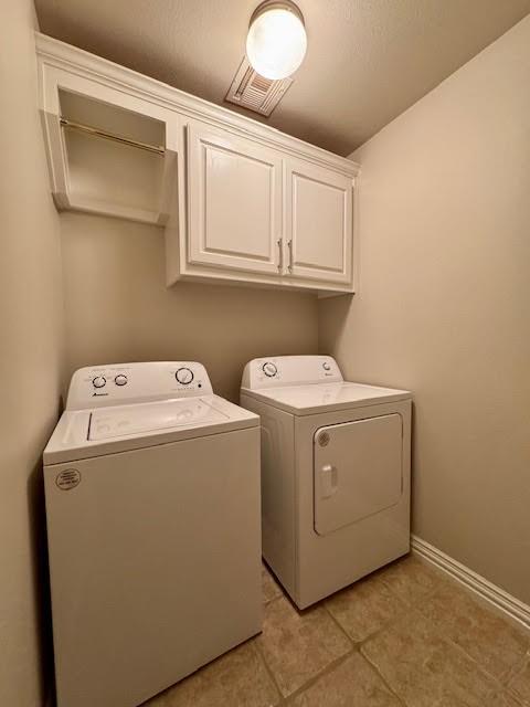 108 Hoss St, Centerton, AR 72719 - laundry room featuring independent washer and dryer, cabinet space, baseboards, and light tile patterned floors