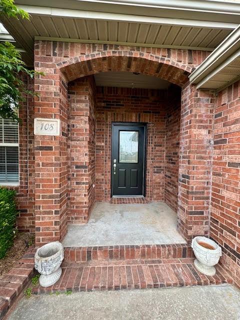 108 Hoss St, Centerton, AR 72719 - doorway to property with brick siding