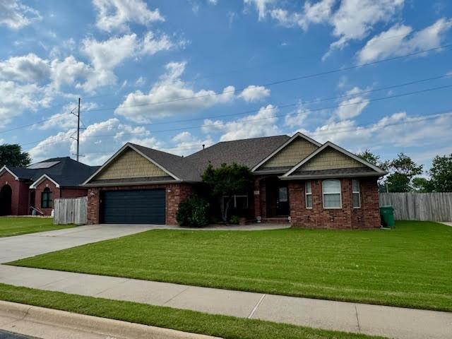 108 Hoss St, Centerton, AR 72719 - view of front of home featuring driveway, an attached garage, and brick siding