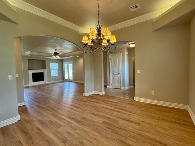 108 Hoss St, Centerton, AR 72719 - unfurnished living room with a ceiling fan, ornamental molding, arched walkways, light wood-style floors, and a tray ceiling