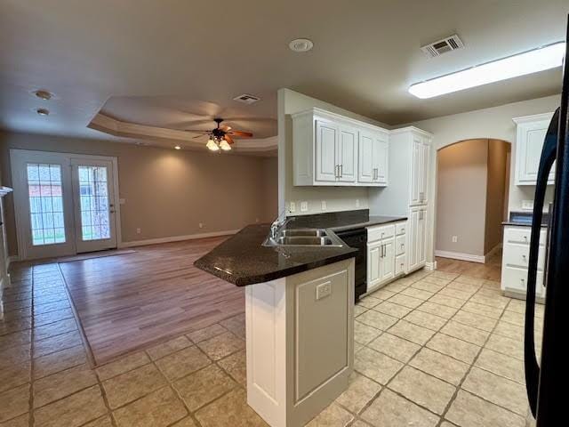 108 Hoss St, Centerton, AR 72719 - kitchen with arched walkways, a raised ceiling, a peninsula, black appliances, and ceiling fan
