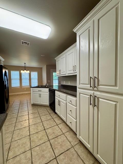 108 Hoss St, Centerton, AR 72719 - kitchen featuring black appliances, a peninsula, a chandelier, dark countertops, and light tile patterned floors