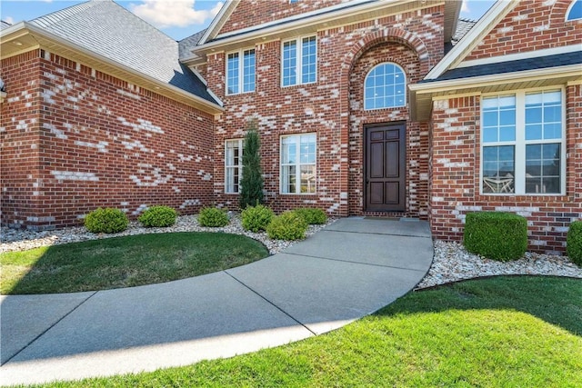 5304 S Promontory Ct, Rogers, AR 72758 - view of exterior entry with brick siding and a lawn