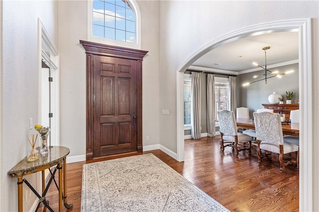 5304 S Promontory Ct, Rogers, AR 72758 - foyer entrance featuring arched walkways, wood finished floors, and ornamental molding