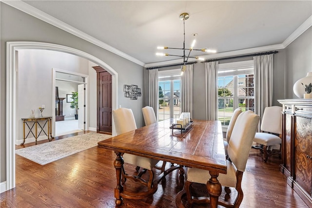 5304 S Promontory Ct, Rogers, AR 72758 - dining area with arched walkways, a chandelier, crown molding, and wood finished floors