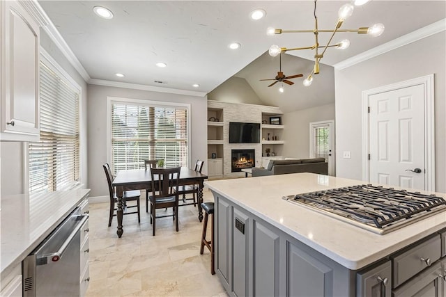 5304 S Promontory Ct, Rogers, AR 72758 - kitchen featuring appliances with stainless steel finishes, gray cabinets, a large fireplace, crown molding, and a ceiling fan