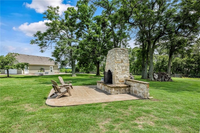 5500 SW Gunstock Rd, Bentonville, AR 72713 - view of yard with an outdoor stone fireplace and a patio area