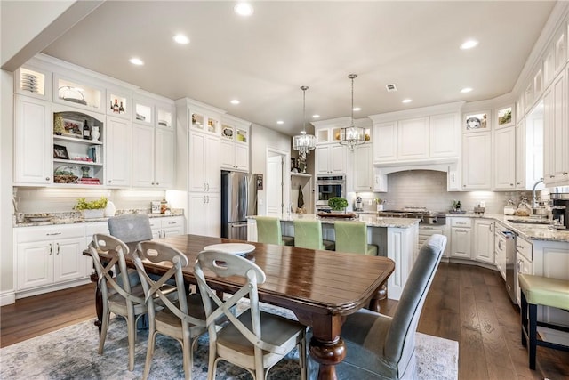 5500 SW Gunstock Rd, Bentonville, AR 72713 - dining space with recessed lighting, dark wood-style flooring, and a chandelier