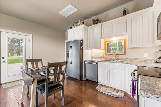 5500 SW Gunstock Rd, Bentonville, AR 72713 - kitchen featuring appliances with stainless steel finishes, a sink, white cabinets, dark wood-type flooring, and light stone countertops