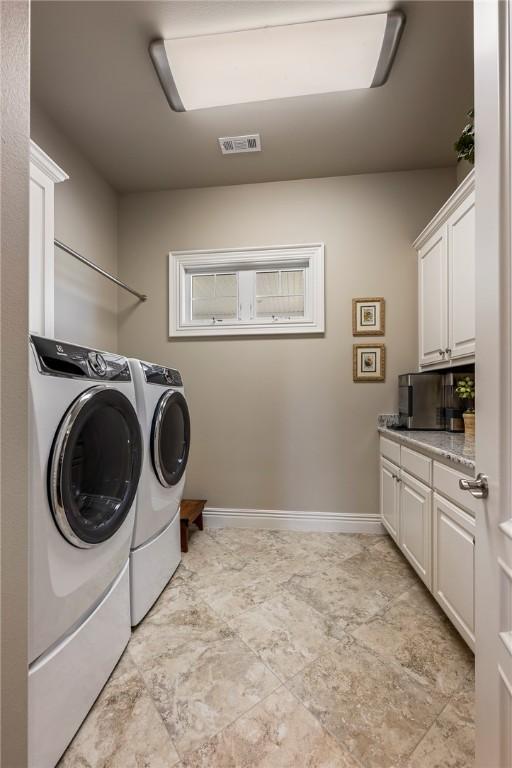 5500 SW Gunstock Rd, Bentonville, AR 72713 - laundry area with independent washer and dryer, cabinet space, and baseboards