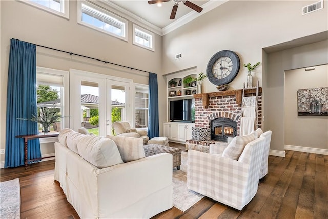 5500 SW Gunstock Rd, Bentonville, AR 72713 - living area featuring a towering ceiling, french doors, ceiling fan, crown molding, and baseboards