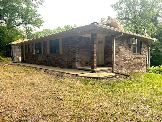 321 F Hwy, Anderson, MO 64831 - view of home's exterior with brick siding, cooling unit, and a yard