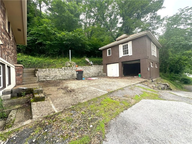 321 F Hwy, Anderson, MO 64831 - view of patio / terrace featuring an attached garage