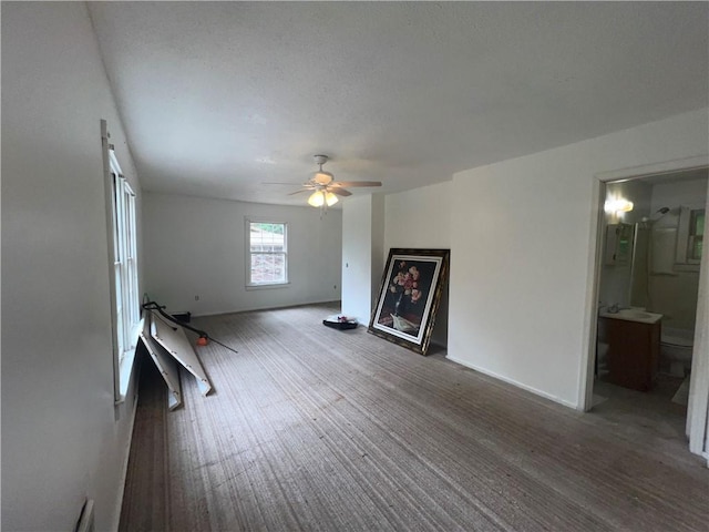 321 F Hwy, Anderson, MO 64831 - unfurnished living room with a ceiling fan and baseboards