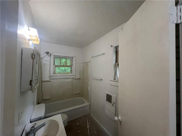 321 F Hwy, Anderson, MO 64831 - bathroom featuring toilet, a textured ceiling, a sink, bathtub / shower combination, and heating unit
