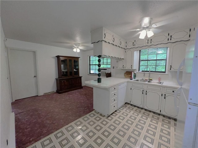 321 F Hwy, Anderson, MO 64831 - kitchen with ceiling fan, a sink, white appliances, a peninsula, and light countertops