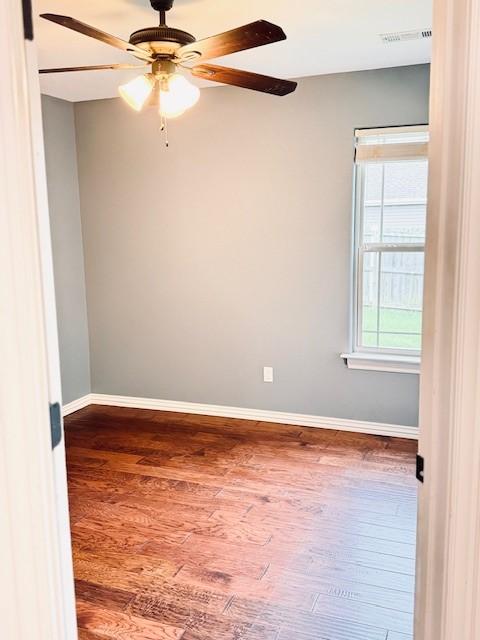 1117 Nemett Dr, Pea Ridge, AR 72751 - unfurnished room with wood finished floors, baseboards, and a ceiling fan