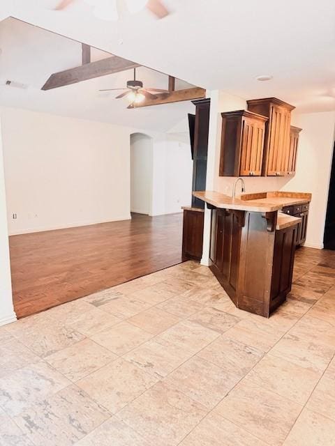 1117 Nemett Dr, Pea Ridge, AR 72751 - kitchen featuring light countertops, arched walkways, a ceiling fan, a peninsula, and open floor plan