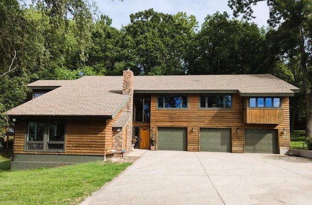 11328 Jolly Mill Ln, Pierce City, MO 65723 - view of front of property featuring driveway, an attached garage, a chimney, roof with shingles, and a front yard