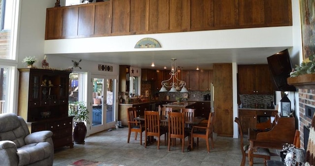 11328 Jolly Mill Ln, Pierce City, MO 65723 - kitchen featuring tasteful backsplash, a towering ceiling, a fireplace, open floor plan, and a chandelier