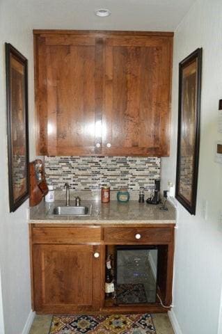11328 Jolly Mill Ln, Pierce City, MO 65723 - kitchen featuring baseboards, brown cabinetry, and decorative backsplash