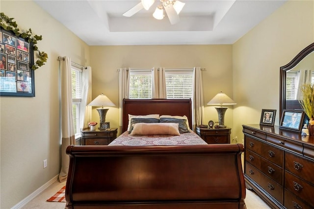 2 Moniave Ln, Bella Vista, AR 72715 - bedroom with a tray ceiling, multiple windows, baseboards, and a ceiling fan